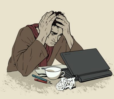 Man in despair sitting at a computer. Headache
